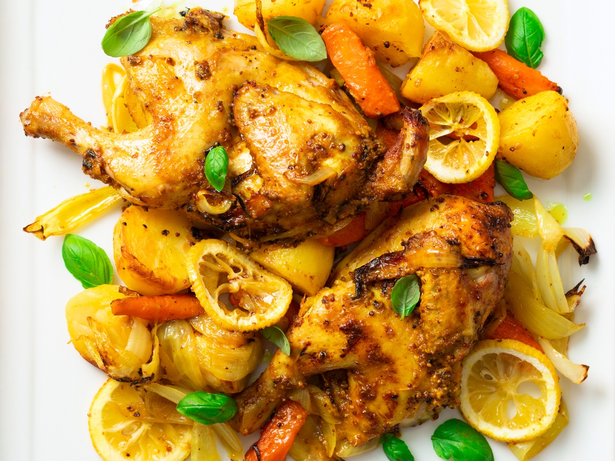 POUSSIN CHICKEN WITH BAKED POTATOES, CARROTS, AND LEMON